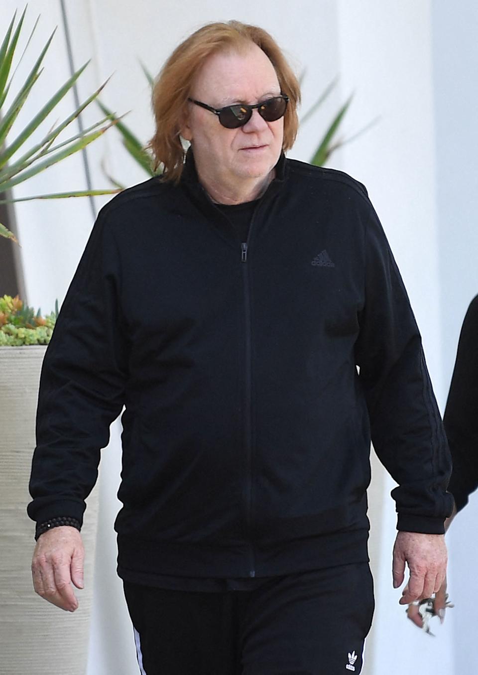 David Caruso carrying paintings outside his art gallery