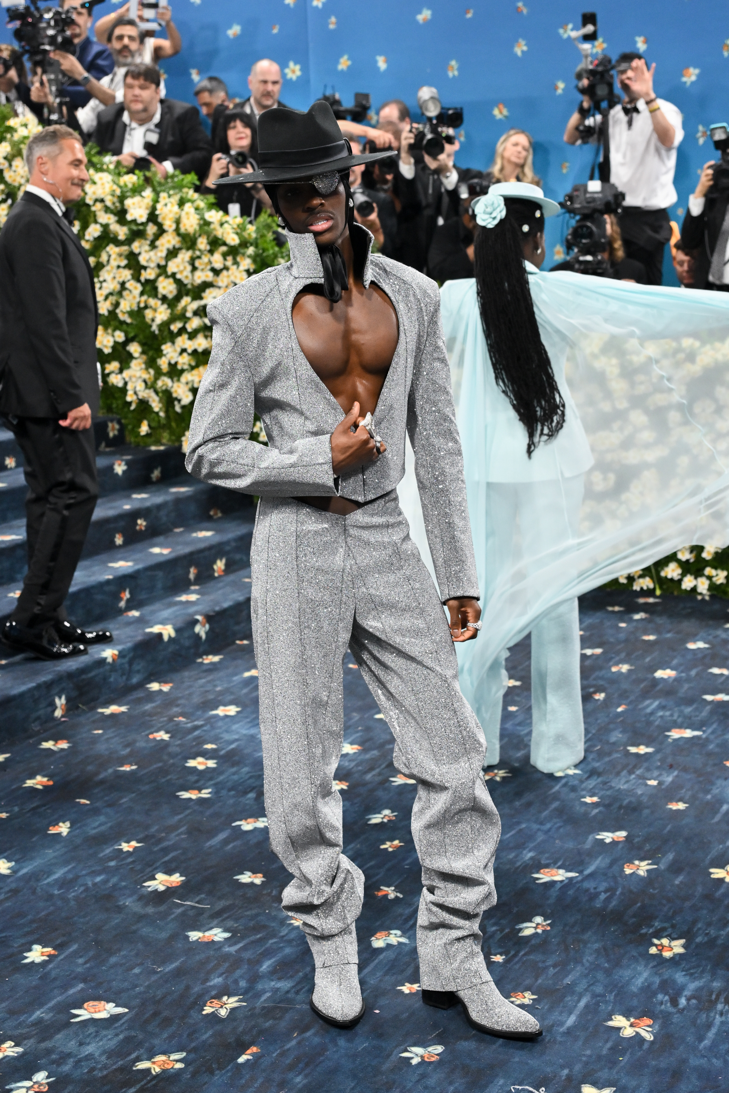 Sabrina Carpenter at the 2025 Met Gala in a pinstriped leotard and tailcoat, exemplifying the event's tailored theme