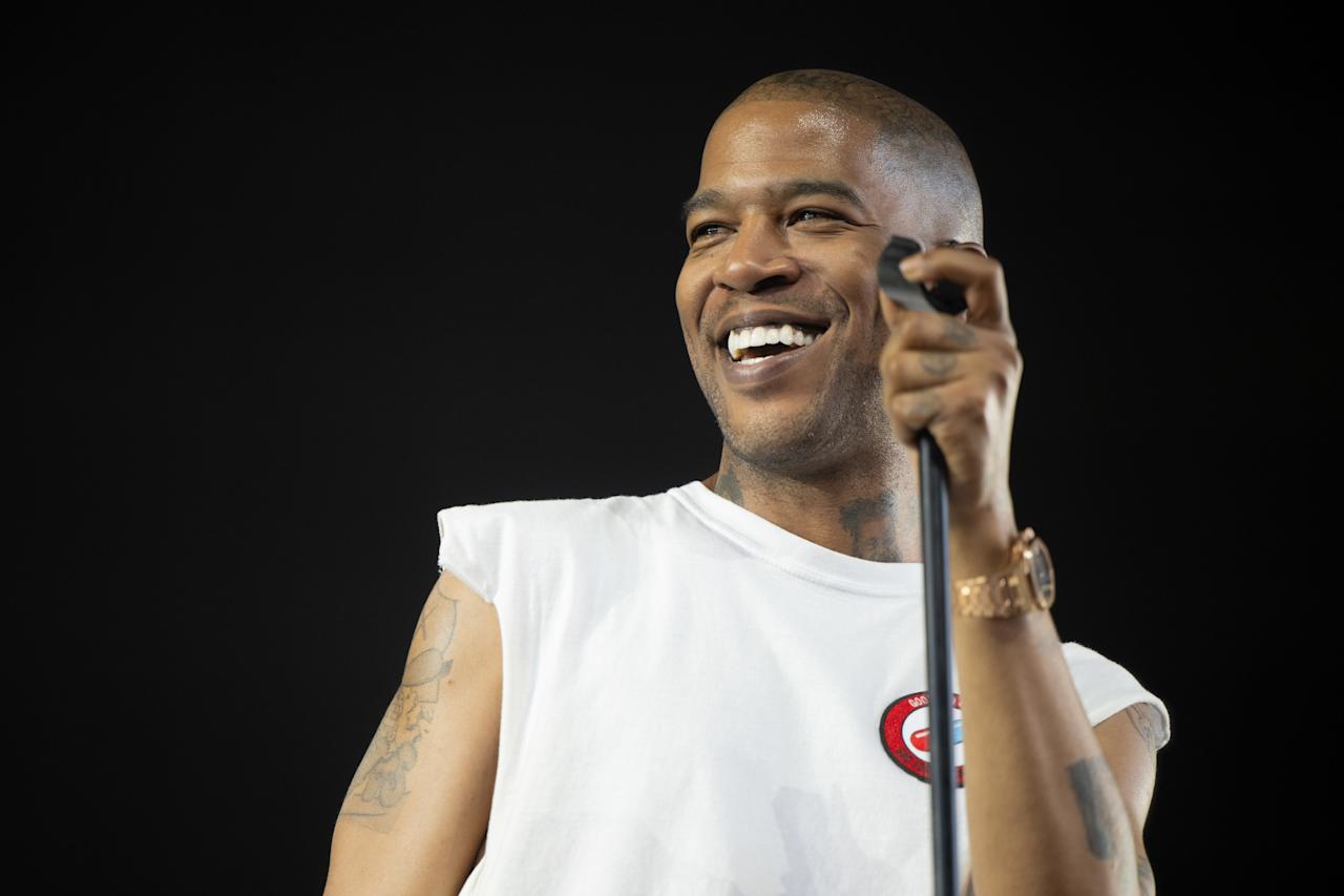 Kid Cudi performing on stage at a major music festival, embodying his unique style and stage presence