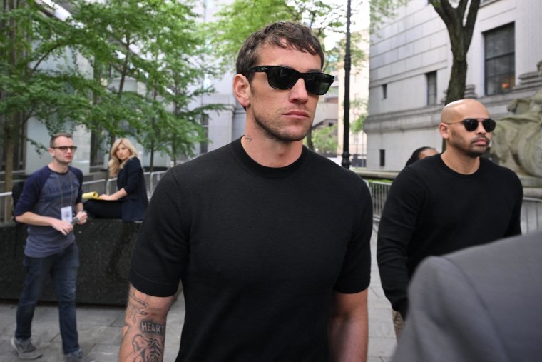 Alex Fine walks alongside Cassie Ventura, showing support outside the courtroom