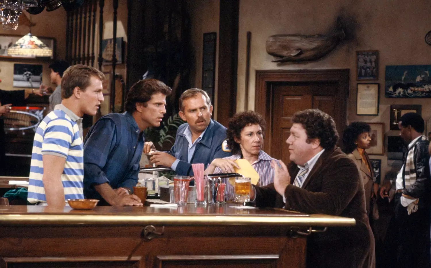 Cast of Cheers, including George Wendt as Norm Peterson