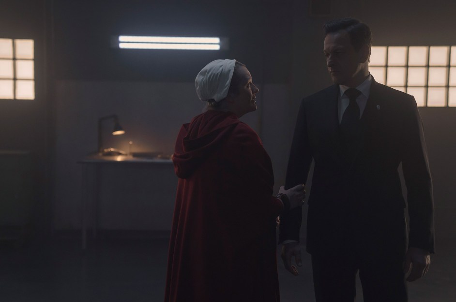 Elisabeth Moss and cast in a dramatic scene from Handmaid's Tale, capturing the impactful use of Taylor Swift's music.