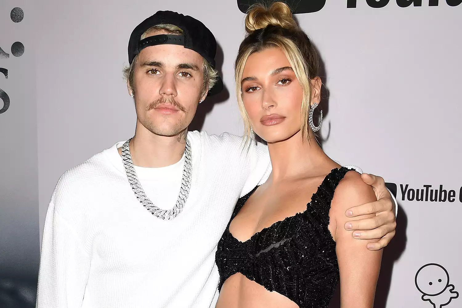 Hailey Bieber posing for Vogue cover shoot, exuding confidence and style